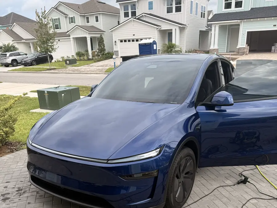 Real customer SUV with a freshly hand-washed, glossy exterior parked in a driveway