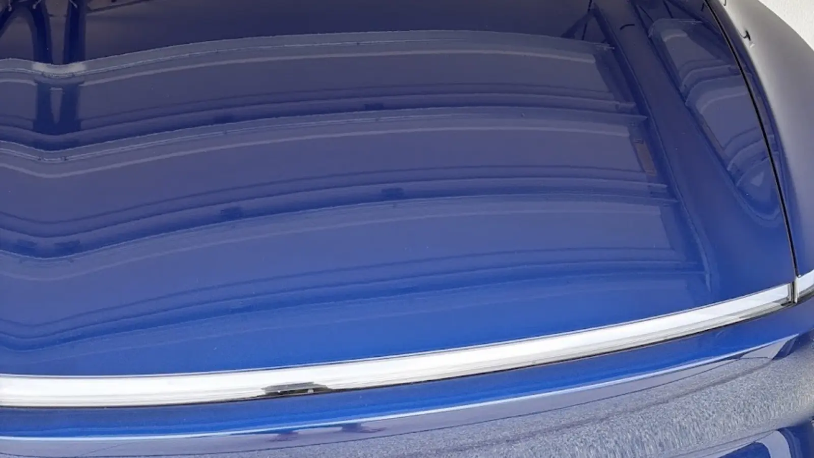 Close-up of a glossy vehicle hood finish after detailing