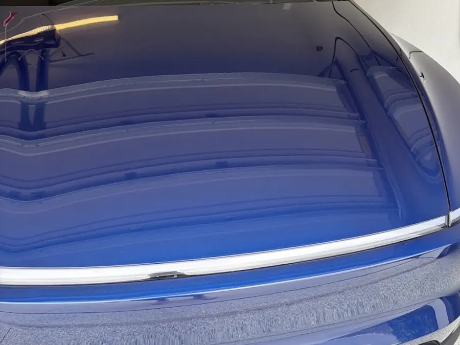 Close-up of a glossy vehicle hood finish after detailing